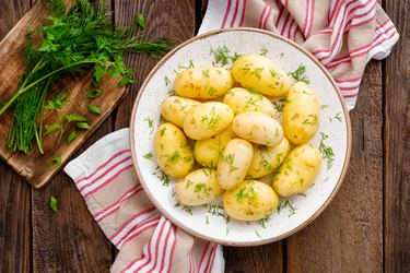 Boiled new potato with butter, dill and green onion